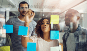 People brainstorming at a white board.