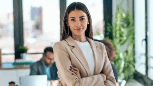 woman tan business jacket smiles in office
