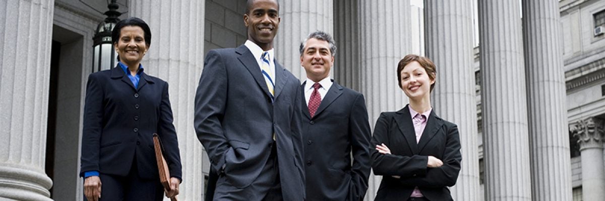 Four professionals in front of government building
