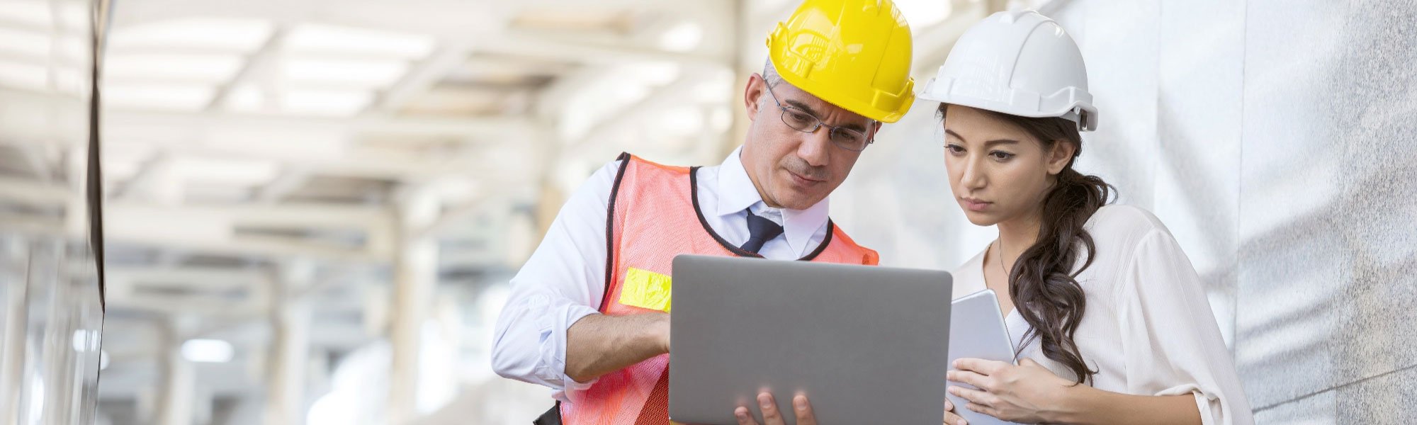 Construction managers looking at information on tablet