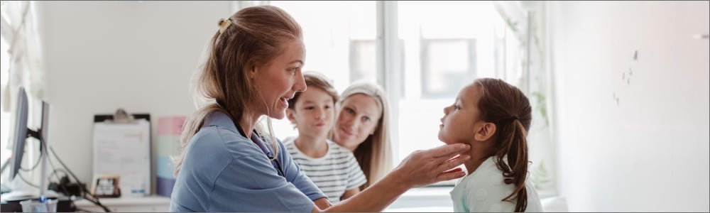 Family nurse practitioner assessing young patient for symptoms