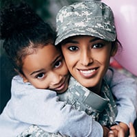 Military woman with her child on her back