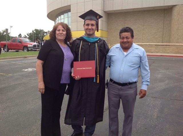 Alberto and his parents at graduation