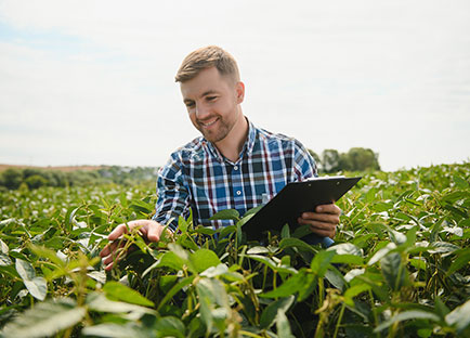 Agriculture student in field with a clipboard