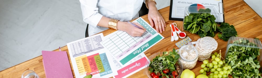 Dietitian writing down meal preparation